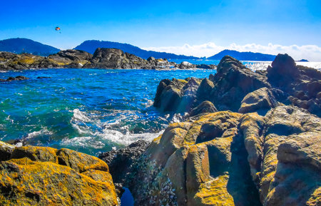 Kalim Beach tropical rocky landscape panorama view with turquoise blue clear water waves sand and rocks in Patong Beach Kathu District Phuket Island Province Southern Thailand in Southeast Asia.の写真素材