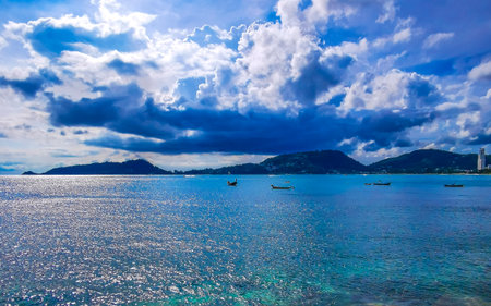 Kalim Beach tropical landscape panorama view with blue sky turquoise water waves and rocks in Patong Beach Kathu District Phuket Island Province Southern Thailand in Southeast Asia.の写真素材