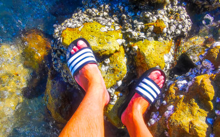 Kathu District Phuket Island Province Thailand December 2nd, 2025 flip flops slippers on the beach...