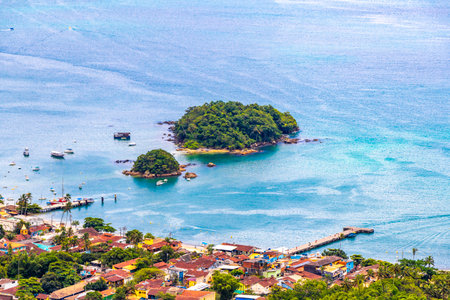 Vila do Abraao village town tropical island sea seascape panorama with beach port pier islands and mountains hills rainforest jungle on Ilha Grande Big Island Angra dos Reis State of Rio de Janeiro Brazil.の写真素材
