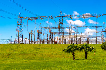 Brazil's largest dam in the world Itaipu for energy production on the border with Paraguay electricity pylons water river and power pole in Foz do Iguacu State of Parana Brazil.の写真素材