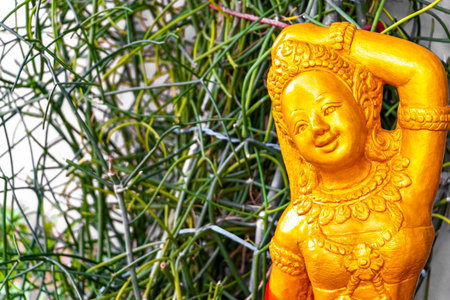 Buddhist mother goddess figure sculpture statue in a tropical zen garden in Patong Beach Kathu District Phuket Island Province Southern Thailand in Southeast Asia.の写真素材