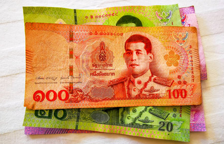 Kathu District Phuket Island Province Thailand October 07, 2025 Thai Baht cash money banknotes paper currency and coins on the table rich luxury life in Patong Beach Phuket Thailand in Southeast Asia.のeditorial素材