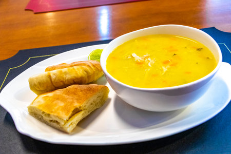 Delicious chicken soup with lime and bread.の写真素材