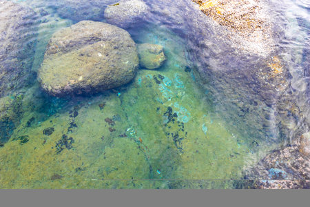 Rocky Kalim Beach tropical seascape shore coast with turquoise blue green clear water waves sand...