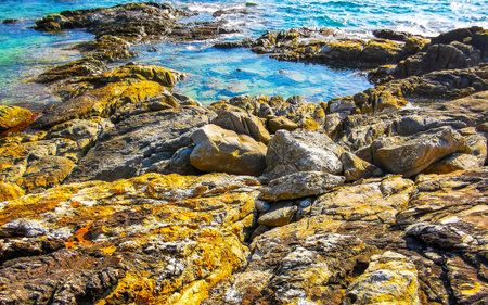 Kalim Beach rocky tropical seascape shore coast with turquoise blue green clear water waves sand...