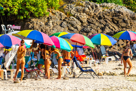 Kathu District Phuket Island Province Thailand 01. March 2026 Patong Kamala Beach bay with tourists people water waves sun loungers parasols tropical plants rocks and palm trees in Phuket Thailand.のeditorial素材