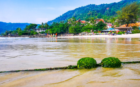 Kathu District Phuket Island Province Thailand 06. March 2026  Blue and turquoise water waves ocean and yellow green buoy mossy algae and ropes in the water in Patong Beach Phuket Island Thailand.のeditorial素材
