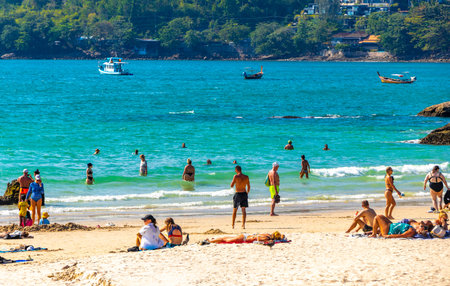 Kathu District Phuket Island Province Thailand 01. March 2026 Patong Beach bay tropical landscape panorama view with tourists people turquoise water waves palm trees rocks in Patong Beach Thailand.のeditorial素材