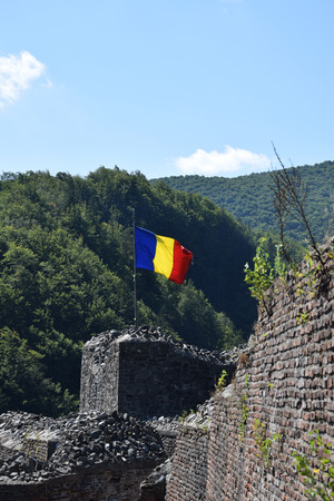 Romanian flag waving in the wind at the ruin of Poenari Castle. Romania National Flag.のeditorial素材