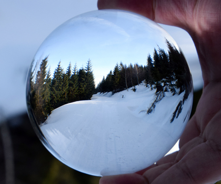 Winter mountain landscape in crystal ball.の写真素材