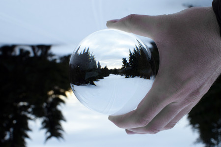 Winter mountain landscape in crystal ball.