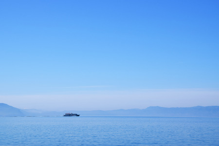 Tourist ship is sailing on Ohrid Lake. Mountain background. Ohrid, Macedonia.の写真素材