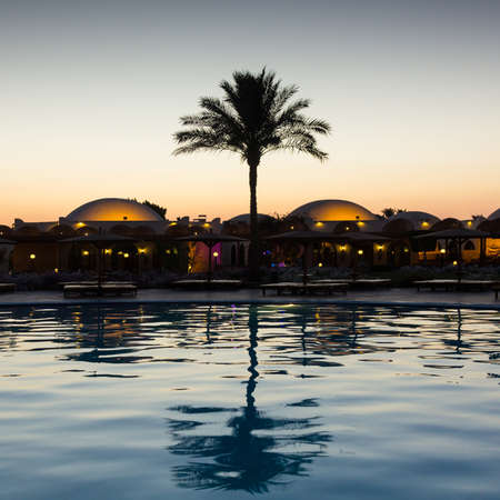 Reflection of trees and buildings  in the water in the evening after sunset.の写真素材