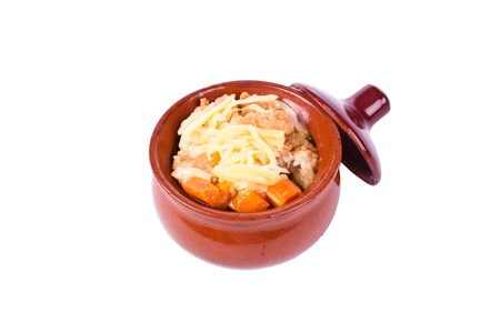 Chicken in a clay pot with vegetables and cheese. background.の写真素材