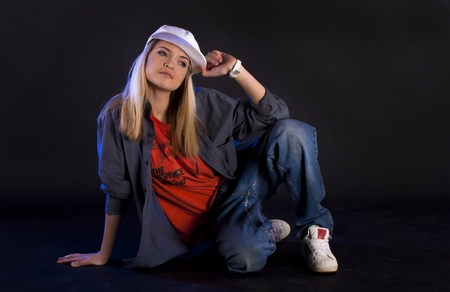 Modern dance, hip hop girl dancer on a black background.の写真素材