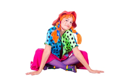 A girl dressed as a clown red. White background. Studio photography.のeditorial素材