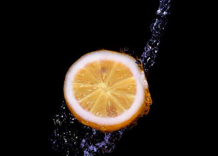 lemon under running waterの写真素材