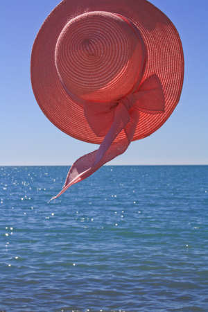 pink hat against the seaの写真素材