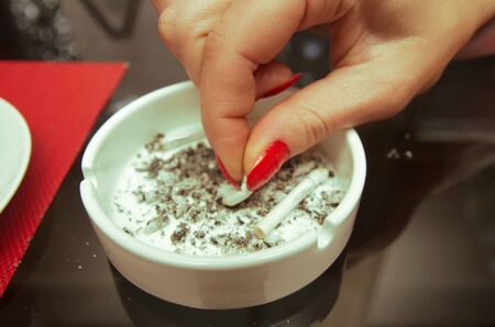 young women put out the cigarette closeupの写真素材