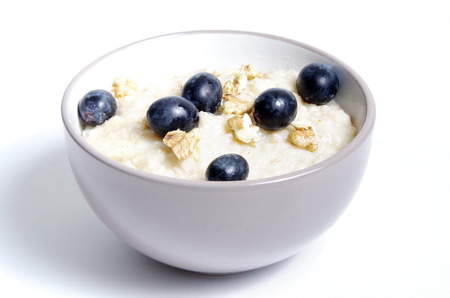 oats with nuts and grapes in bowl closeup isolatedの写真素材