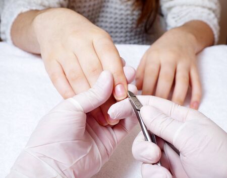 woman is getting manicure service in a salonの写真素材