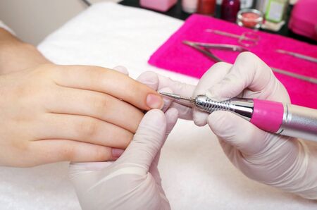 woman is getting manicure service in a salonの写真素材
