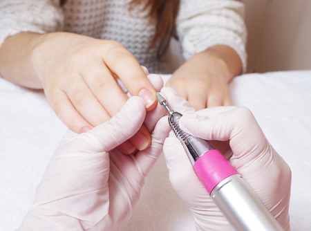 woman is getting manicure service in a salonの写真素材