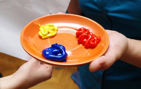 colorful paint on a plate ready to useの写真素材