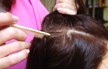 hairdresser prepares customer for haircut in a salonの写真素材