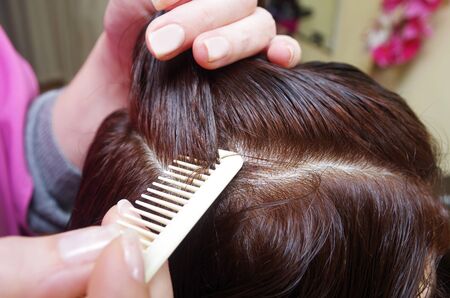 hairdresser prepares customer for haircut in a salonの写真素材