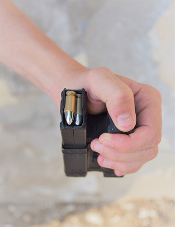 a man is holding cartridges for airsoft gameの写真素材