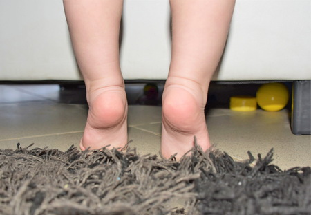 toddler tryes to make first stepの写真素材