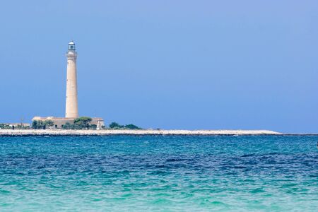 Seascape with lighthouse in the background, San Vito Lo Capo in Sicilyの写真素材
