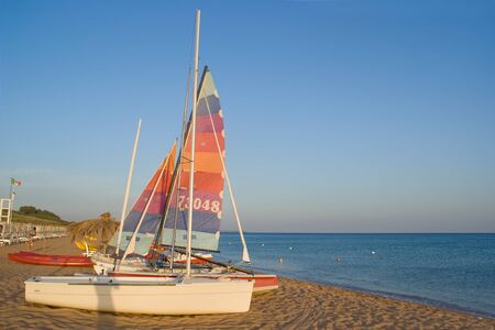 Sailboats on the beach at sunsetのeditorial素材