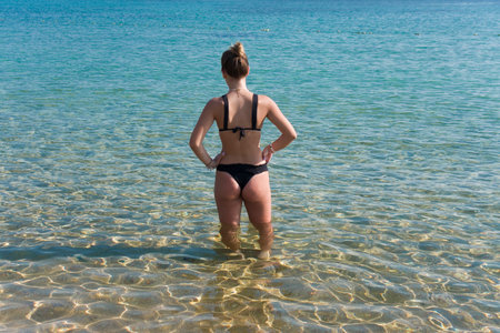 Girl at the seaside from behindの写真素材