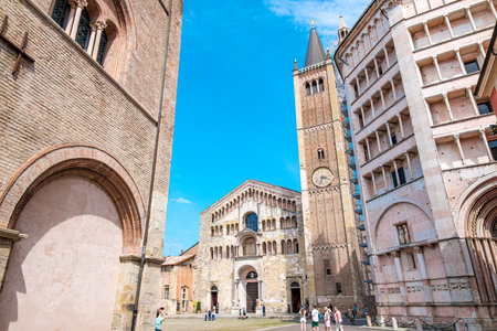 Parma Cathedral and Baptistery with its imposing bell tower dominate Piazza del Duomo in Parma, Emilia Romagna, Italy, creating a breathtaking view of Italian Romanesque architectureの写真素材