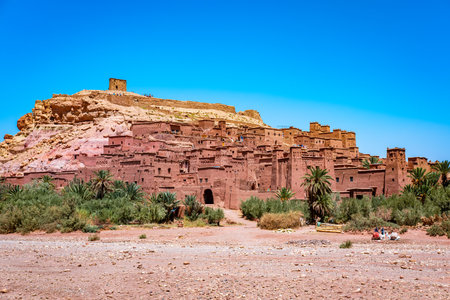 Ait Benhaddou, a historic ksar on a hill near Ouarzazate, highlights traditional earthen architecture and reflects Moroccos rich cultural heritage under a clear blue skyの写真素材