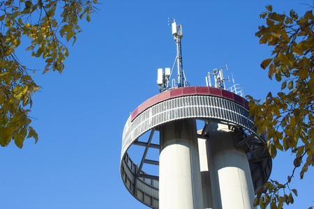 antennas on the roof of a building against the blue skyの写真素材