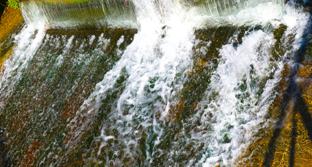 A small waterfall on the urban riverの写真素材
