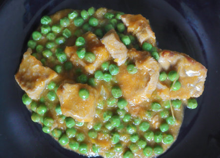 Veal stew with peas and onion on dark backroundの写真素材