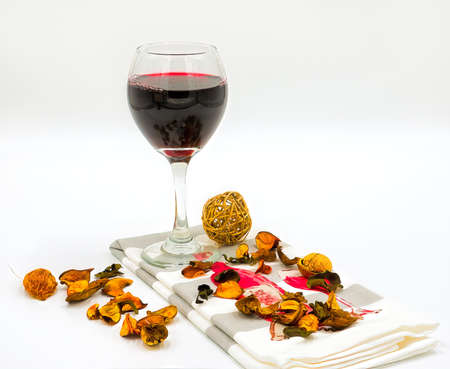 Wine on a white background and some flowersの写真素材