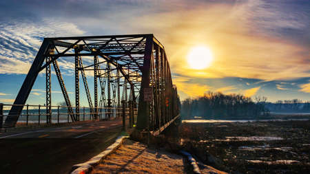 A train crossing a bridge over a body of waterの写真素材
