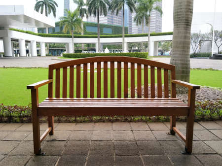 WTC II, Sudirman, Jakarta, Indonesia - April 28, 2020 : Long bench made of wood in the office area parkのeditorial素材