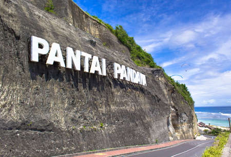 Pantai Pandawa, Bali, Indonesia - December 1, 2018 : Hill that has the words "Pantai Pandawa". this location is on the beach many tourists who play paraglidingのeditorial素材