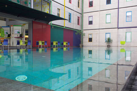 Pop hotel, Kuta, Bali - December 1, 2020 : The corner of the swimming pool, there are hotel visitors who are relaxingのeditorial素材