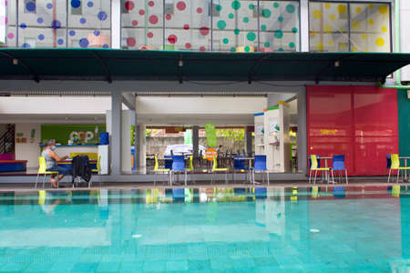 Pop hotel, Kuta, Bali - December 1, 2020 : The atmosphere of the swimming pool inside the hotel with colorful ambientのeditorial素材