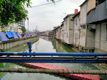 Tambora, jakarta, Indonesia - (04-03-2021) : Slum house in front of a dirty river in a densely...