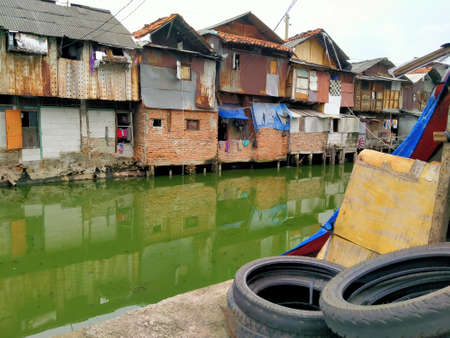 Tambora, jakarta, Indonesia - (04-03-2021) : Slum house in front of a dirty river in a densely populated areaのeditorial素材