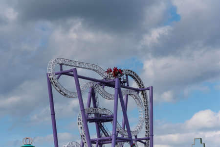 People enjoying rollercoaster at theme park.の写真素材